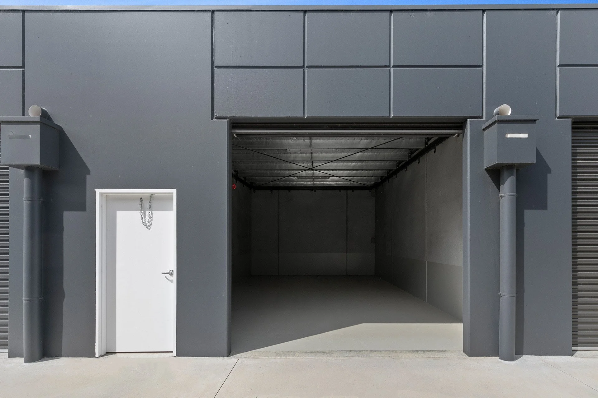 Open AlterSpaces Breakwater storage unit with roller door and personnel access door